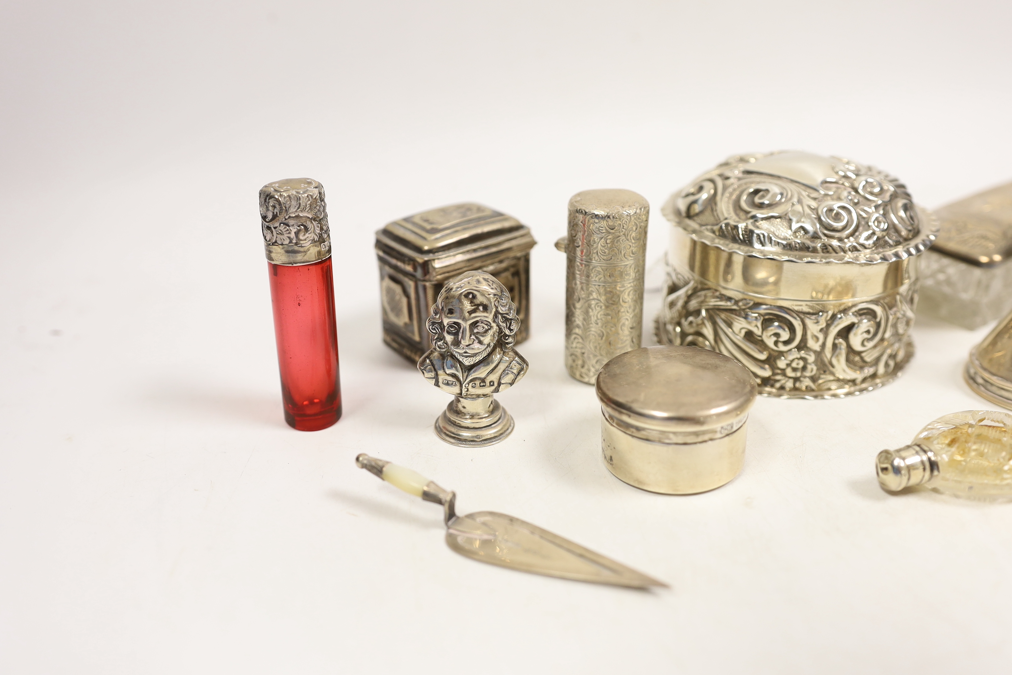 Small silver including two silver mounted glass toilet boxes, a Victorian engraved scent bottle by Sampson Mordan, a perfume funnel, Edwardian Shakespeare bust seal, repousse box and cover, locket, bookmark, etc.
